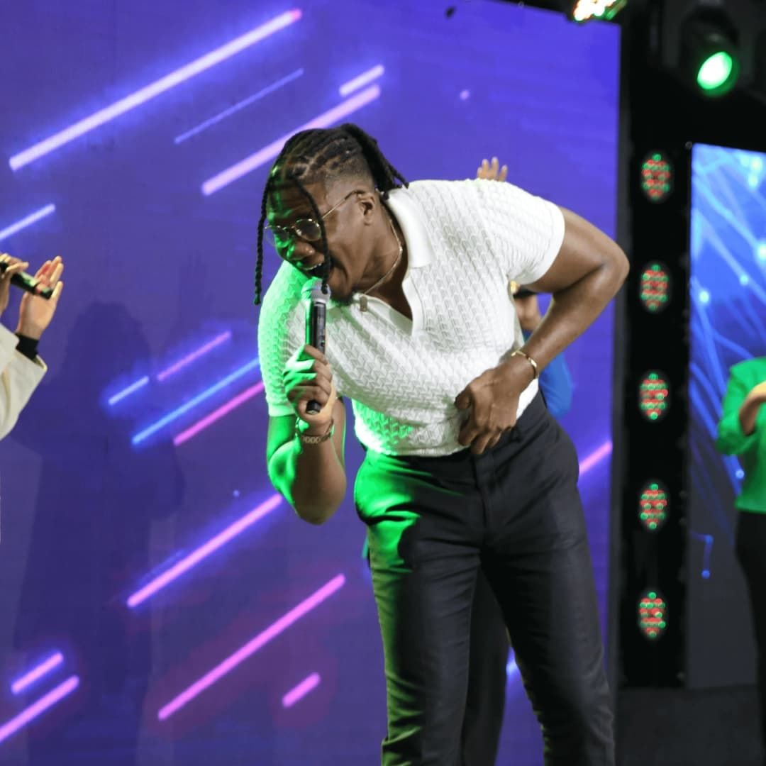A worship minister singing passionately on stage